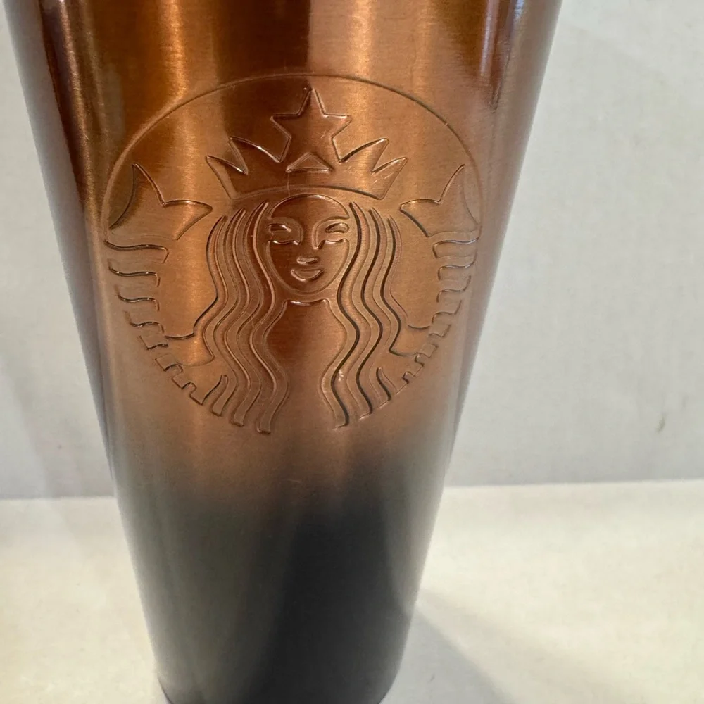 Starbucks Copper colored tumbler that transitions to a black bottom